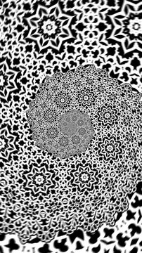 Seamless vertical video of a black and white mandala pattern swirl. Geometric graphic spiral with a psychedelic look.