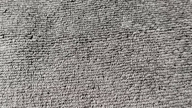 Close-up of soft towel fabric texture featuring highly detailed cotton loops and absorbent fibers. Ideal as a background, textile pattern, bathroom concept, fabric material reference, or design resour