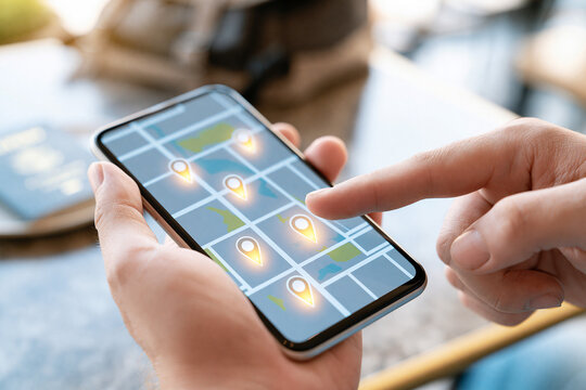 A person's hands holding a smartphone displaying a modern digital map with several glowing location pins.