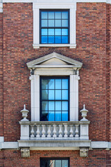Fototapeta premium Classic Georgian architecture featuring a white multi-pane window on a red brick building at Harvard University in Cambridge Massachusetts
