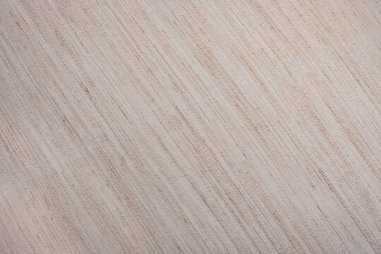 Beige fabric texture. A beige background with a pattern of lines.