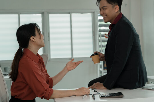 Business Colleagues Chatting and Laughing at Office Desk