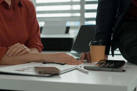 Business Colleagues Chatting and Laughing at Office Desk