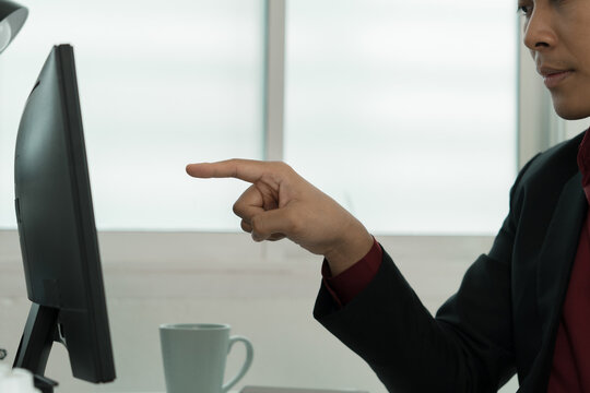 lose-Up of Focused Businessman Pointing at Computer Monitor