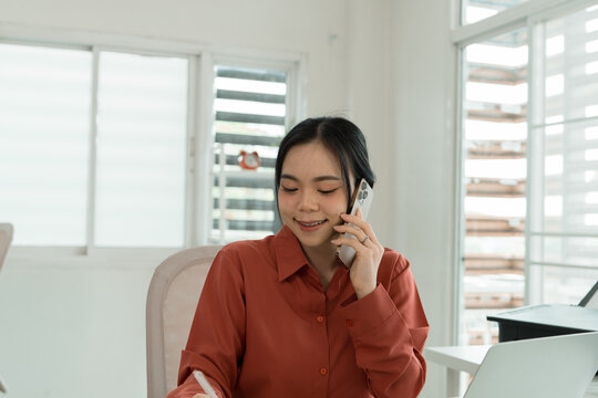 Businesswoman Gesturing While on Phone Call in Office