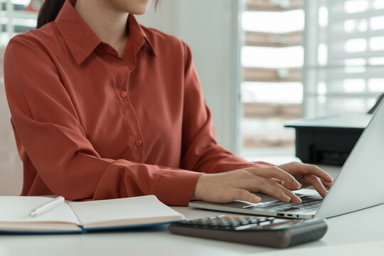 Close-Up of Businesswoman Typing on Laptop at Office Desk