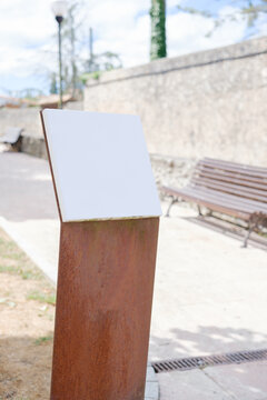 Blank information sign on rustic metal stand