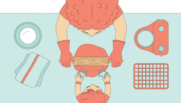 Mother and child wearing matching coral aprons and gloves use a wooden rolling pin to flatten dough with star shapes on a light green workspace.
