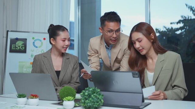 Business team collaborating on ESG strategy and corporate social responsibility in a modern office meeting