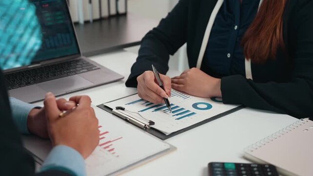 Business colleagues analyzing financial data charts and graphs during a corporate meeting in the office