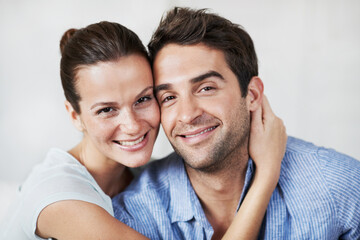 Obraz premium Portrait, couple and relax at house with smile, love and partner support for bonding together. Happy, people and rest in home with embrace, admiration and marriage connection for healthy relationship