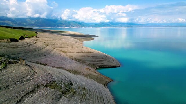 Vivid Drone Shot Capturing Geological Formations And Tranquil Scenery of high mountain lake