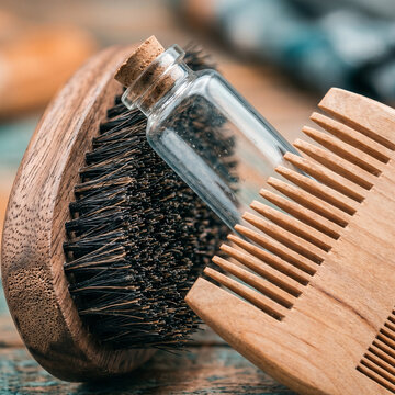 Grooming Essentials: Beard Brush, Comb, and Oil Bottle on Rustic Wooden Surface