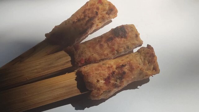 Authentic Balinese sate lilit, a traditional Indonesian satay made from seasoned minced meat wrapped around skewers and grilled to perfection.