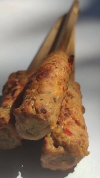 Authentic Balinese sate lilit, a traditional Indonesian satay made from seasoned minced meat wrapped around skewers and grilled to perfection.