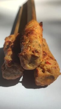 Authentic Balinese sate lilit, a traditional Indonesian satay made from seasoned minced meat wrapped around skewers and grilled to perfection.