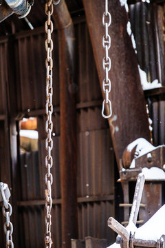 chains from broken crane on abandoned factory