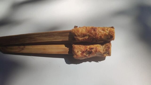 Authentic Balinese sate lilit, a traditional Indonesian satay made from seasoned minced meat wrapped around skewers and grilled to perfection.
