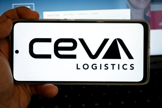 Hand holding mobile phone displaying ceva logistics logo