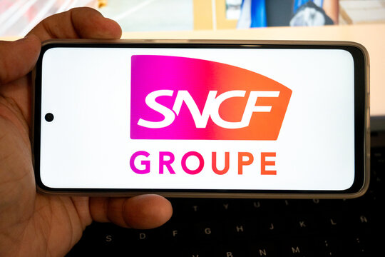 Hand holding smartphone displaying sncf groupe logo