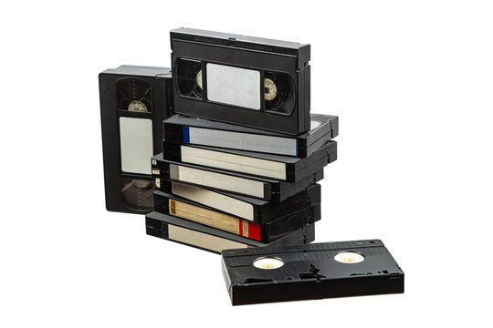 A stack of old VHS videotapes with blank labels isolated on a white back