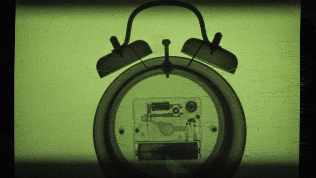 the process of creating an X-ray image of a mechanical watch with an alarm clock, captured on camera
