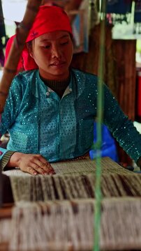 Vietnamese artisan woman weaving traditional fabric on a loom