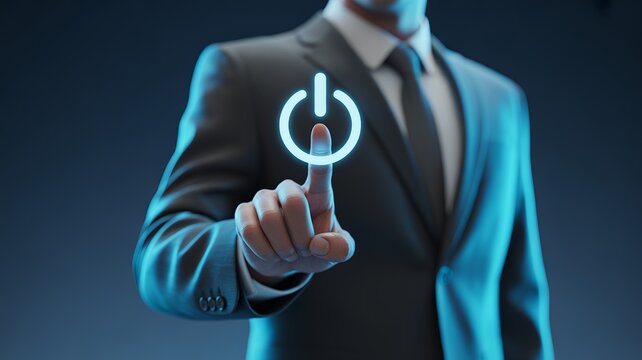 Professional businessman in a dark suit pressing a glowing blue power button icon with finger