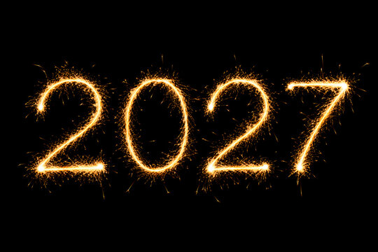 Bright sparkling 2027 numbers made of burning sparklers isolated on dark black background.