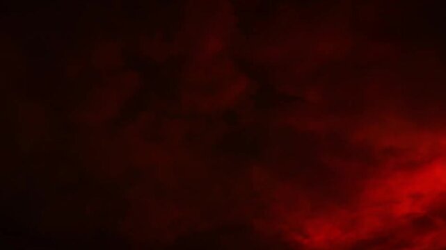 Intense red lightning storm and dark dramatic clouds in the night sky