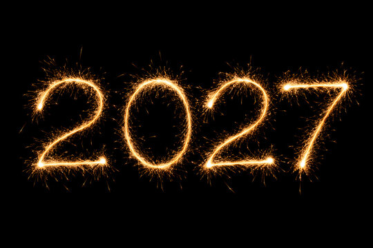 Happy new year 2027 written with sparklers isolated on a black background.