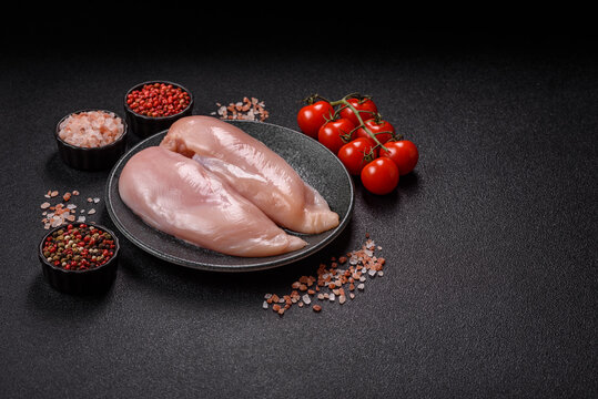 Fresh raw chicken fillet with salt and spices for home cooking. Raw chicken fillet