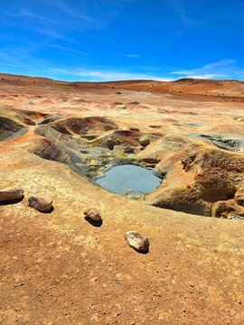 Geiser in a mineral-rich desert landscape