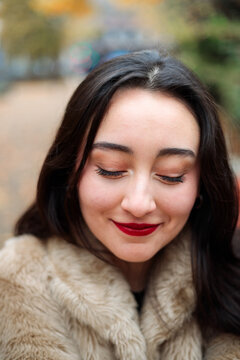 Young woman looking down with shy gaze