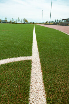 Green soccer field with white corner marking. Sports field for training and competitions. Leisure activity, sports facility, soccer field, recreational activities, sports club.