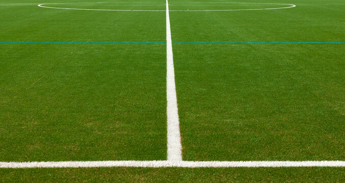 Green soccer field with withe center mark. Sports field for training and competitions. Leisure activity, sports facility, soccer field, recreational activities, sports club.