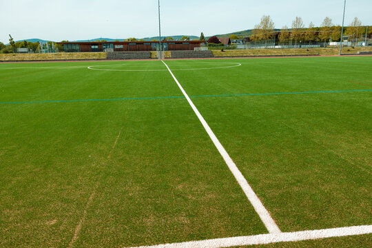 Green soccer field with withe center mark. Sports field for training and competitions. Leisure activity, sports facility, soccer field, recreational activities, sports club.