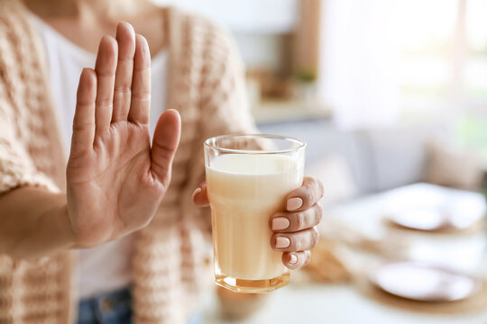 牛乳を拒否する手：乳糖不耐症や牛乳アレルギーのイメージ