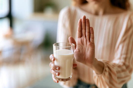 牛乳を拒否する手：乳糖不耐症や牛乳アレルギーのイメージ