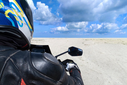 Biker closeup, white sand and blue sky