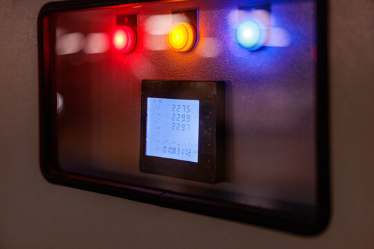 Control panel with colored lights and digital power display.
