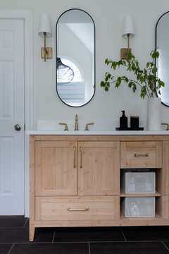 Modern Double Vanity Bathroom with Brass Fixtures and Oval Mirrors