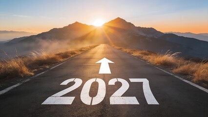 Obraz premium White number 2027 painted on an asphalt road leading toward a bright sun rising behind majestic mountain peaks in a scenic landscape during the early morning