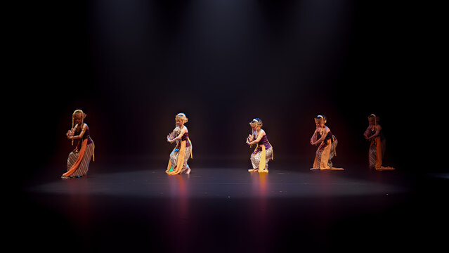 Wide Theater Scene with Traditional Dancers Under Spotlight