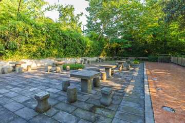 A seating area with stone pillars and bollards in a park in China © alexmu