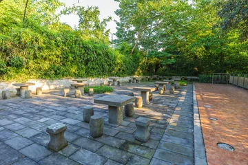 A seating area with stone pillars and bollards in a park in China © alexmu