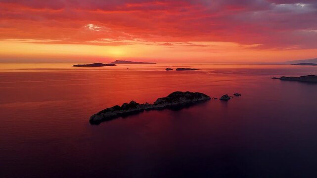 Scenic aerial view of Diapontia Islands during a stunning red sunset over the Ionian Sea