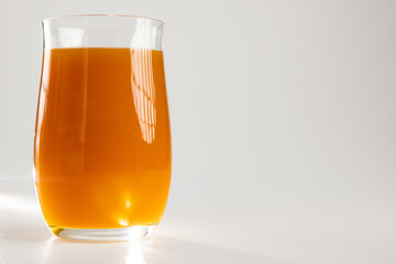 Glass of fresh orange juice isolated on white background © Ruslan