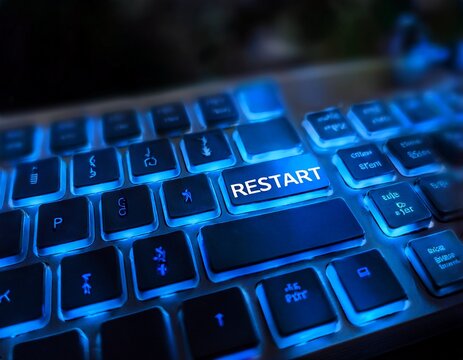 a close up shot of a keyboard featuring an illuminated restart key with a vibrant blue light representing the concept of beginning anew or refreshing a technological process
