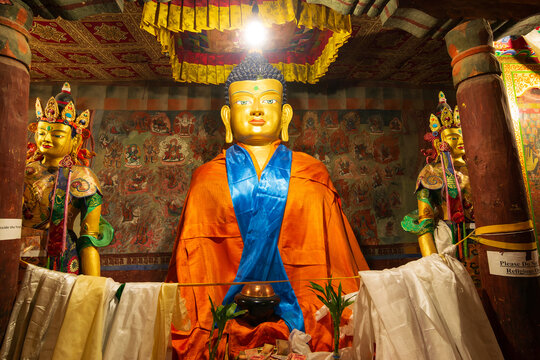Thiksay, Leh, Ladakh, India - 05.09.2014 : Large seated Maitreya Buddha statue adorned in traditional robes, Interior of Maitreya Temple within Thiksay Monastery. Buddhist monastery, Tibetan Buddhism.